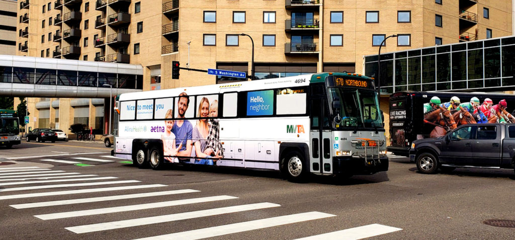 A bus wrapped in an advertisement for Aetna