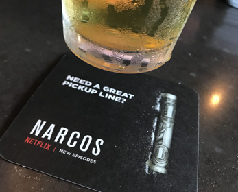 A Narcos advertisement on bar coasters by AllOver Media