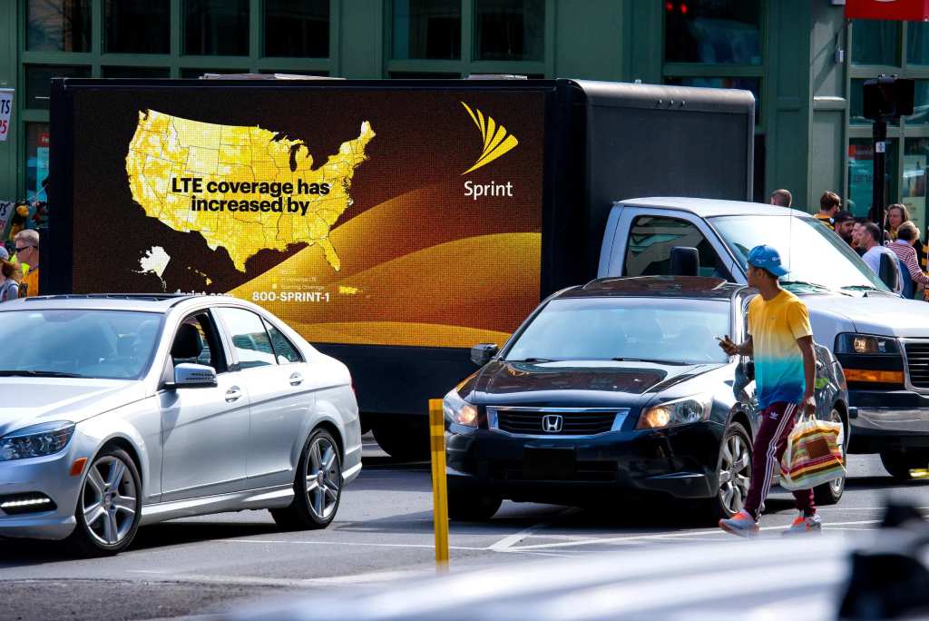 Digital billboard truck driving in the city