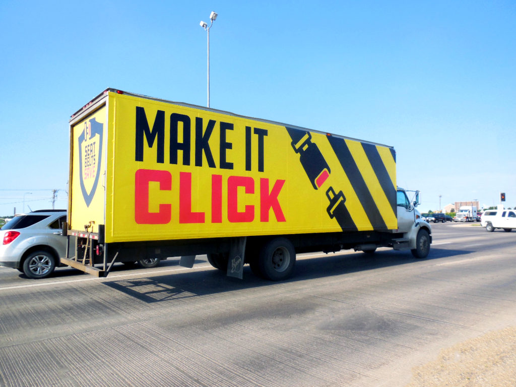 Truck that says "Make it click" with a seatbelt on it