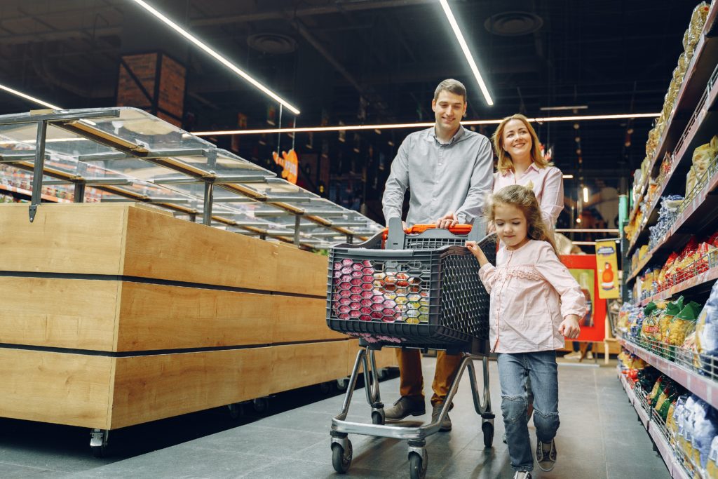 Family in a grocery store. DOOH can work wonderfully in this setting.