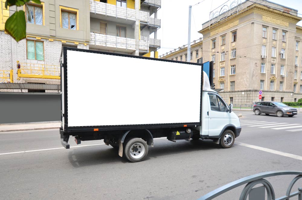 Commercial truck with empty mockup banner on a van.
