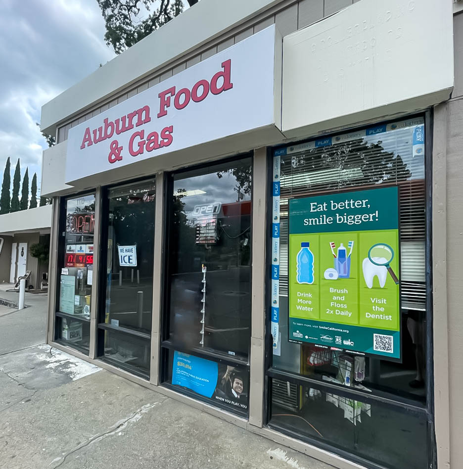 Advertisements displayed in the windows of the Auburn Food and Gas store