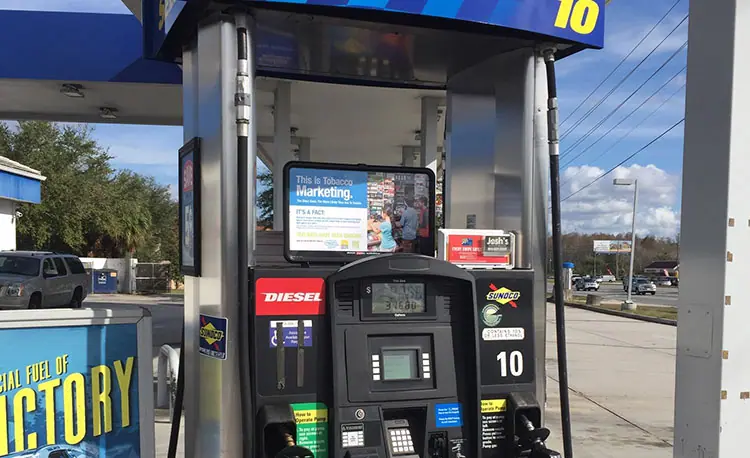 Sunoco gas pump wiht advertisements on and around it