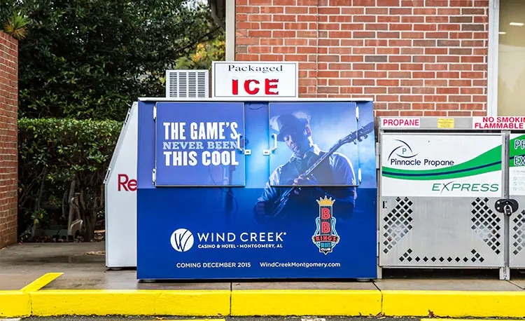 Gas station ice box that is wrapped with a Wind Creek Casino ad