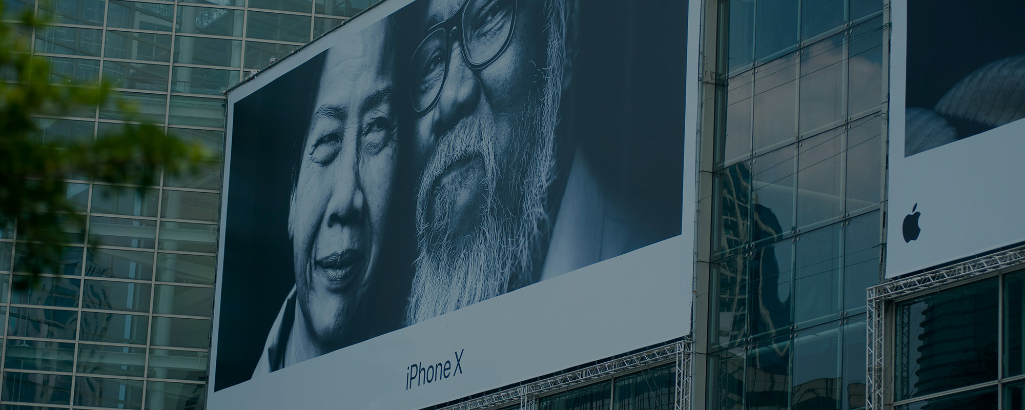 Large building-side advertisement for the iPhone X