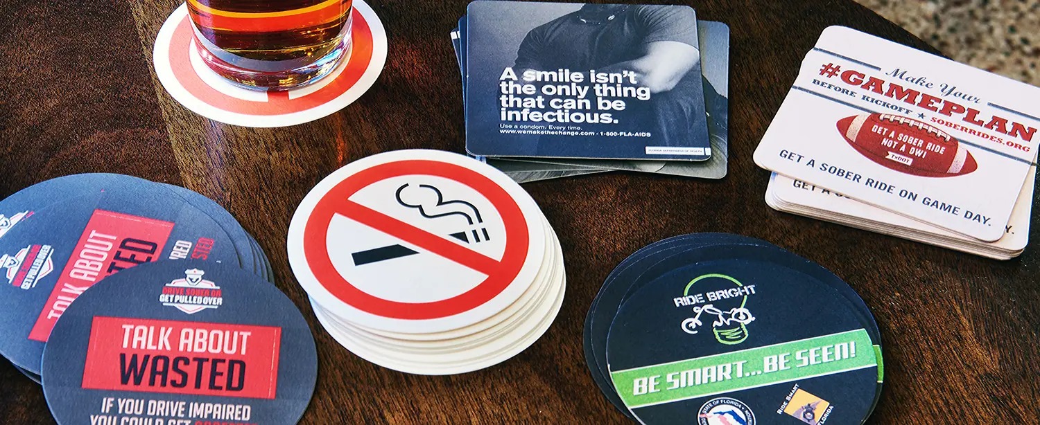 Custom designed bar coasters to spread targeted causes